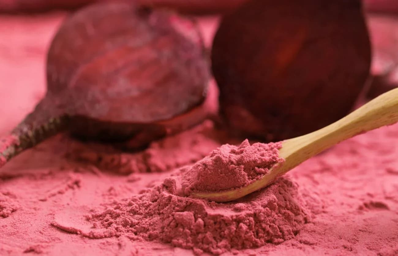 Vibrant magenta dehydrated beetroot powder close-up