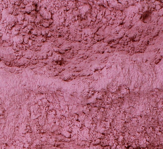 Fine dehydrated red onion powder in a measuring bowl